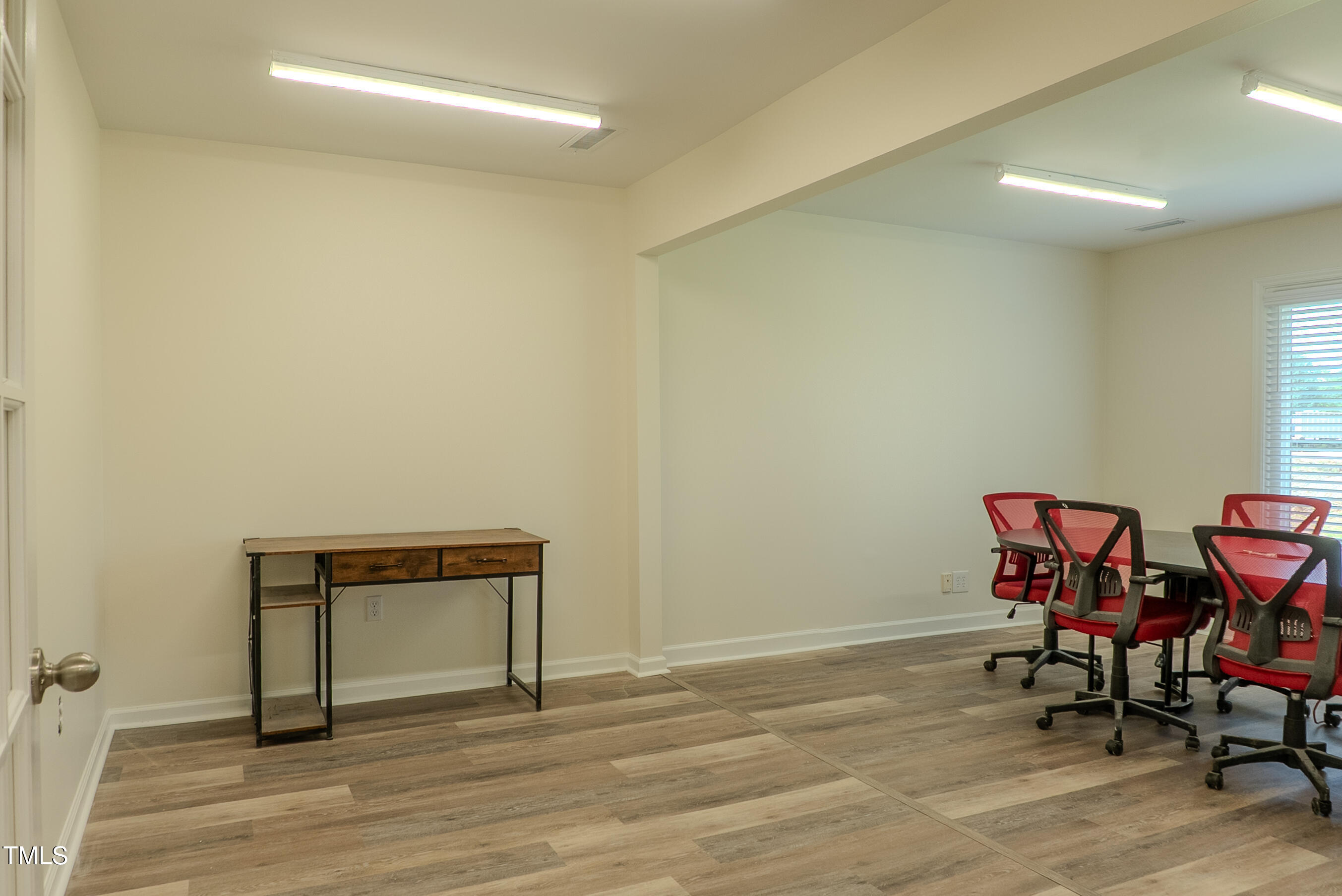 6504 Burlington Road Whitsett, NC 27377 - Photo 17 of 34 a view of a room with wooden floor and lounge chairs