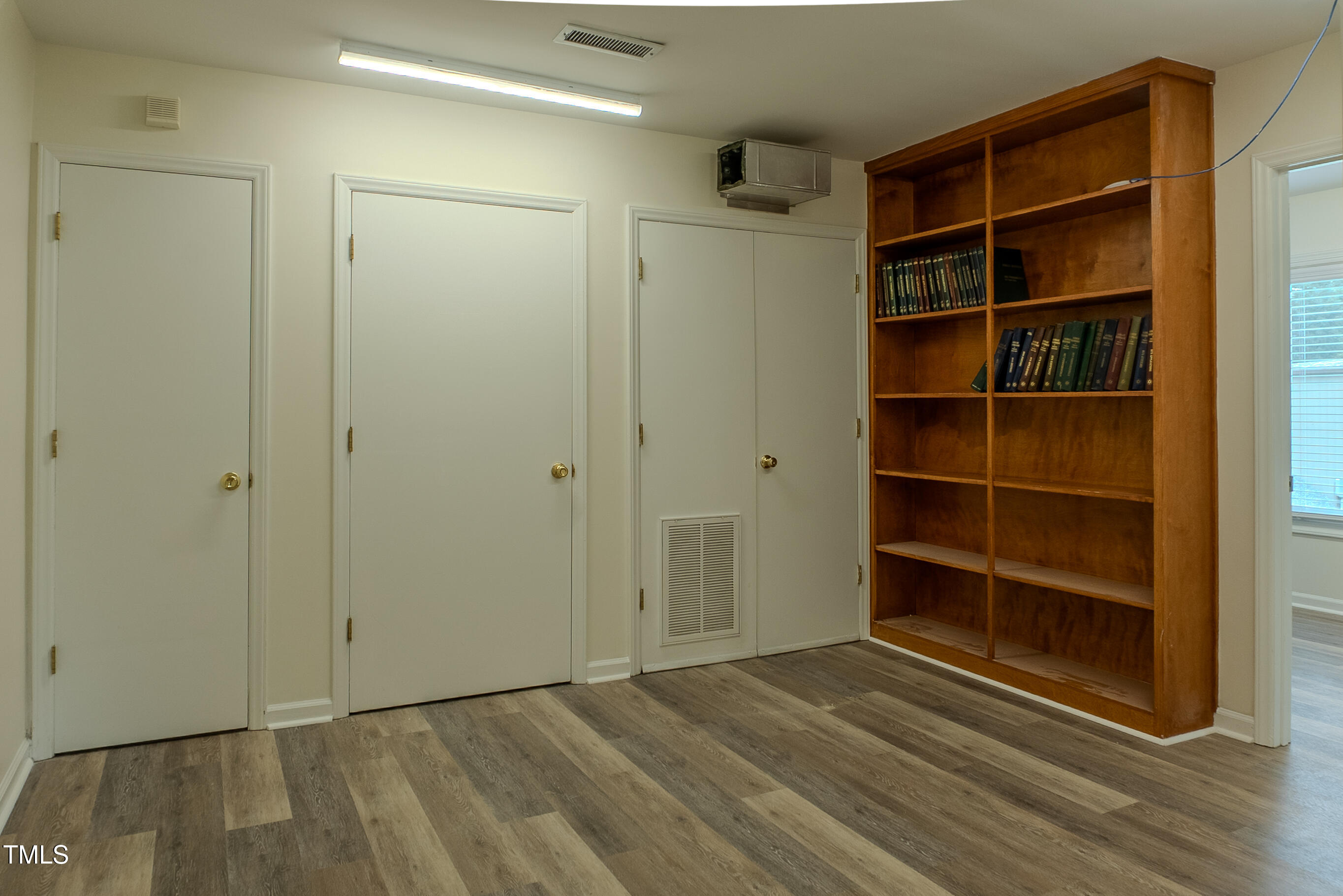 6504 Burlington Road Whitsett, NC 27377 - Photo 20 of 34 a view of an empty room with a empty space and a window