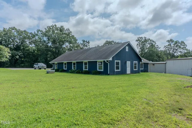 a front view of a house with yard and green space