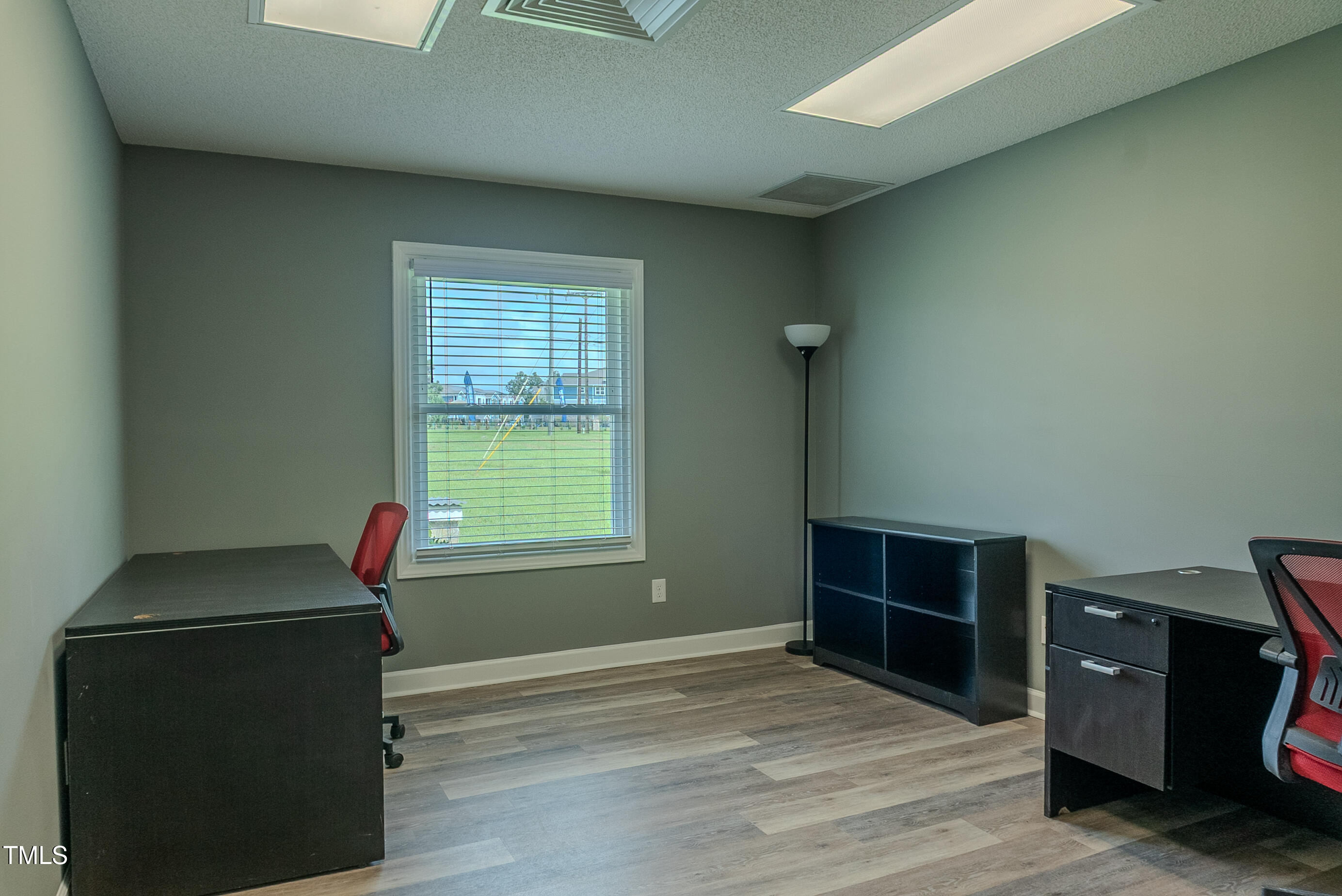 6504 Burlington Road Whitsett, NC 27377 - Photo 10 of 34 a view of a livingroom with an empty space and a window