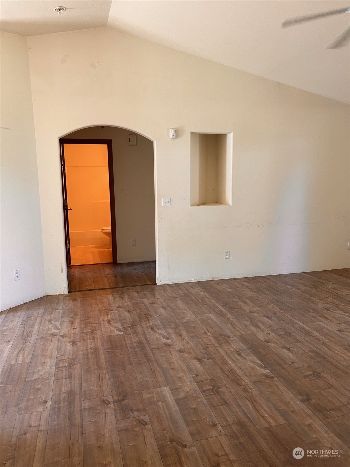 9520 185th Avenue Southwest Rochester, WA 98579 - Photo 11 of 24 a view of an empty room with wooden floor and a window