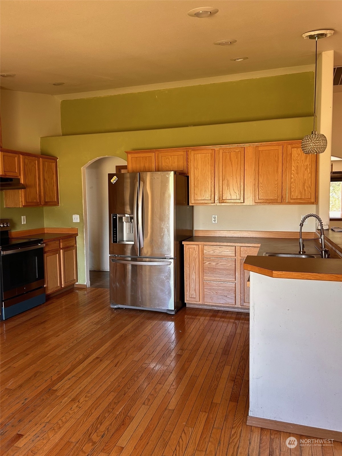 9520 185th Avenue Southwest Rochester, WA 98579 - Photo 13 of 24 a kitchen with granite countertop a refrigerator and a sink