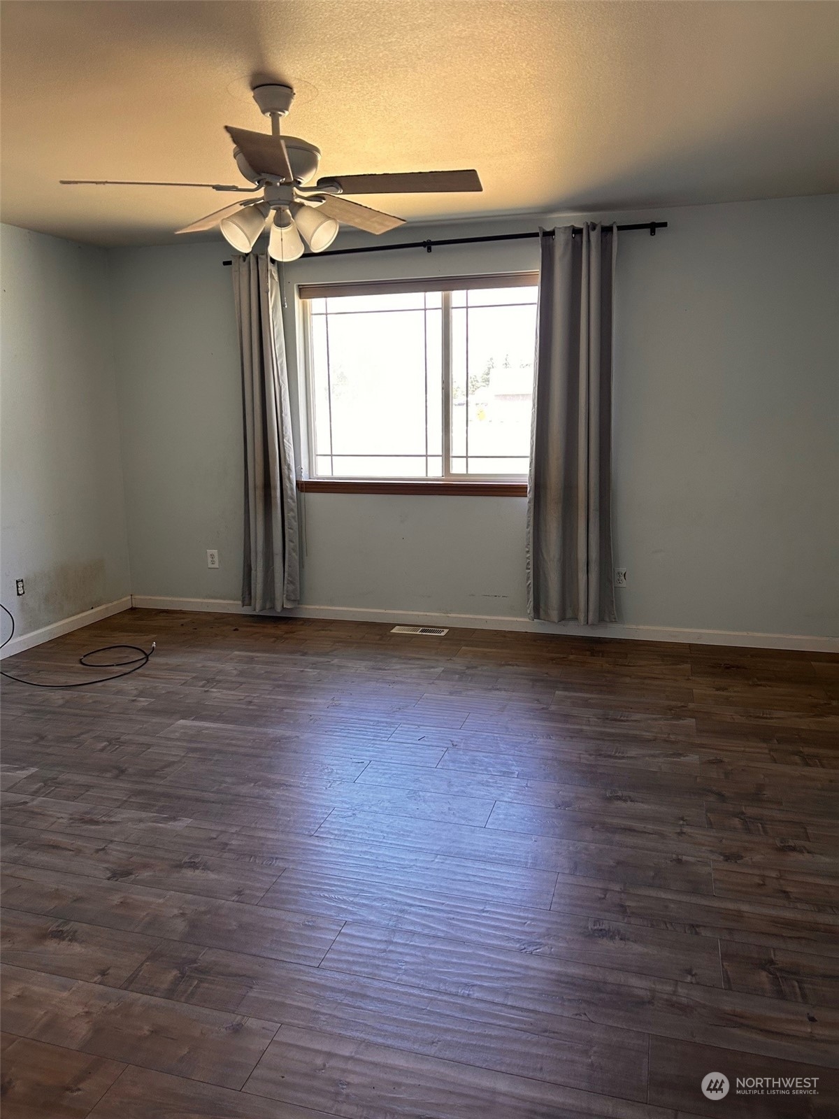 9520 185th Avenue Southwest Rochester, WA 98579 - Photo 17 of 24 wooden floor in an empty room with a window