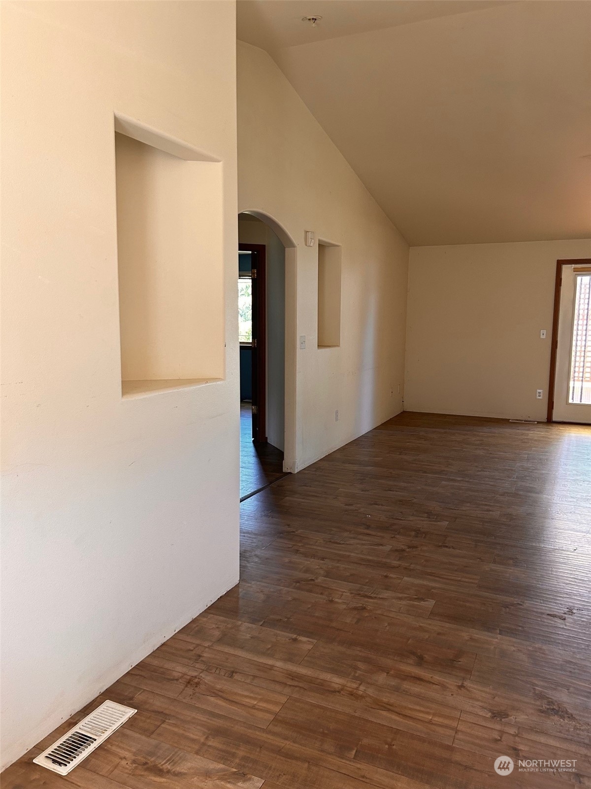 9520 185th Avenue Southwest Rochester, WA 98579 - Photo 9 of 24 a view of an empty room with wooden floor and a window