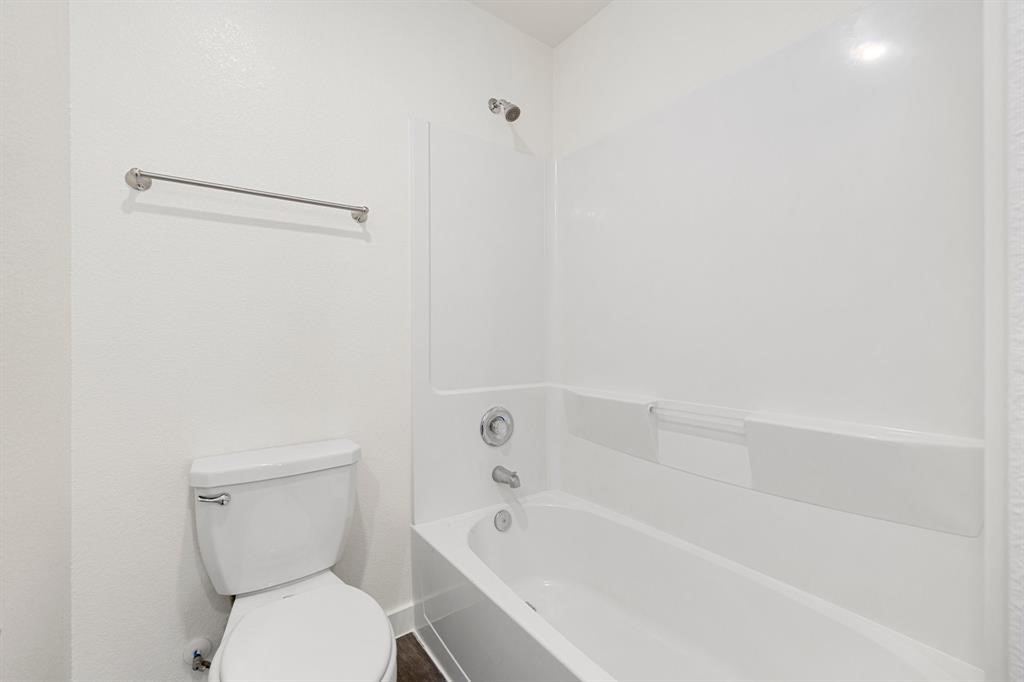 12603 Telge Road, Unit 32 AD Cypress, TX 77429 - Photo 11 of 13 a bathroom with a toilet and a bathtub