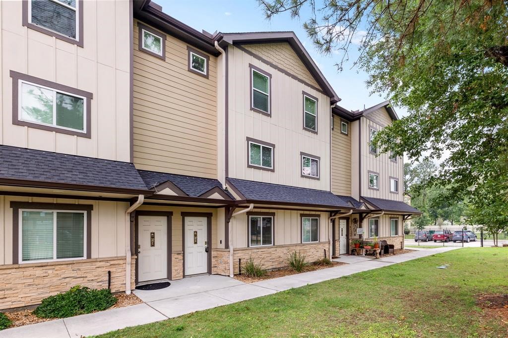 12603 Telge Road, Unit 32 AD Cypress, TX 77429 - Photo 5 of 13 a front view of a house with a yard and trees