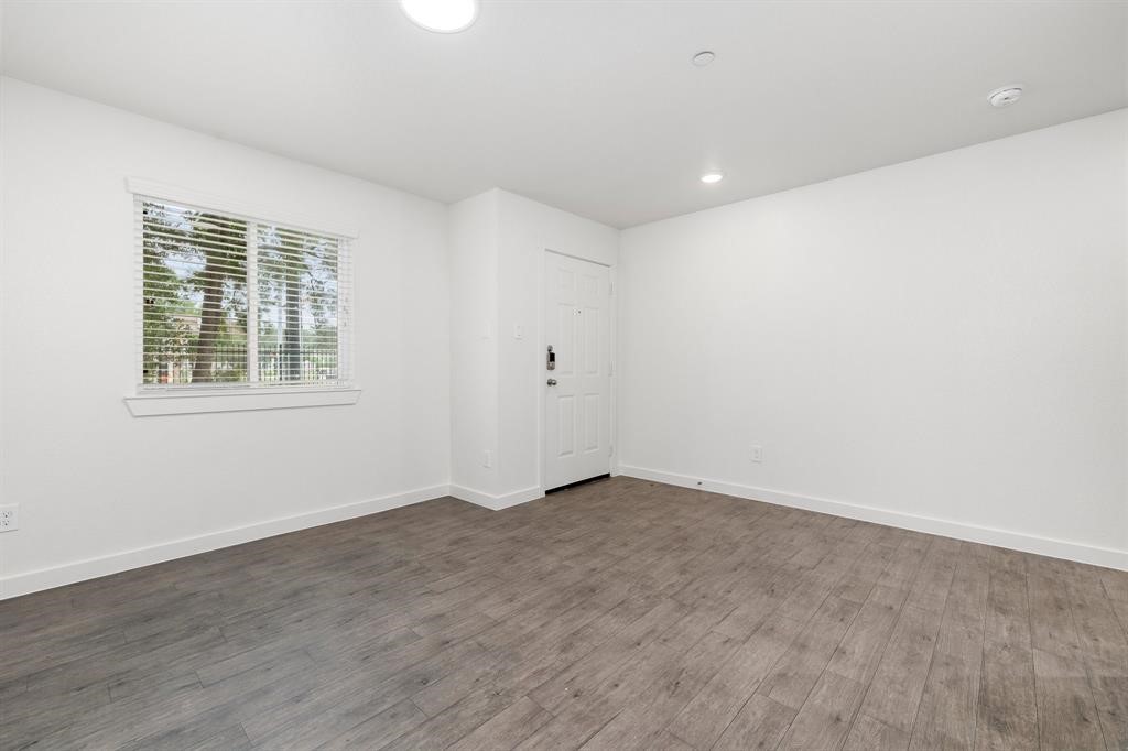 12603 Telge Road, Unit 32 AD Cypress, TX 77429 - Photo 6 of 13 a view of an empty room with wooden floor and a window
