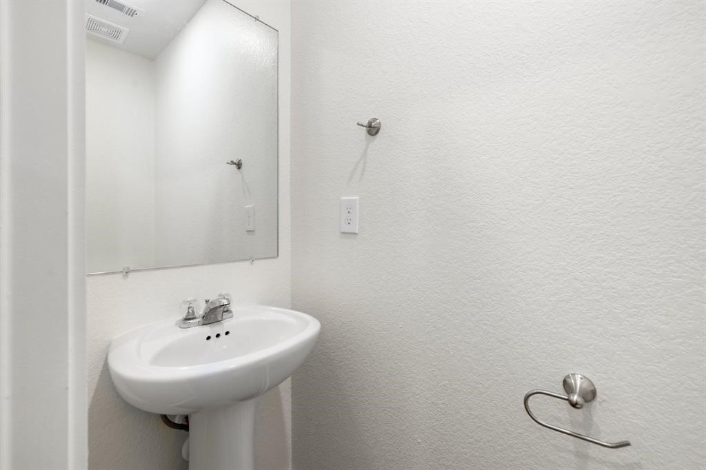 12603 Telge Road, Unit 32 AD Cypress, TX 77429 - Photo 9 of 13 a bathroom with a sink a mirror and toilet