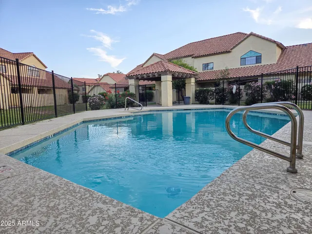 a swimming pool with some trees in the background