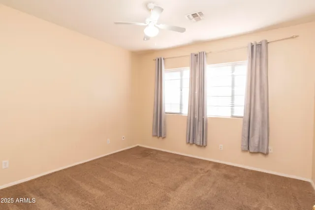 an empty room with windows and closet