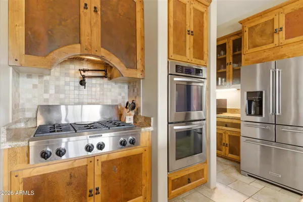 a kitchen with stainless steel appliances granite countertop a stove and a refrigerator