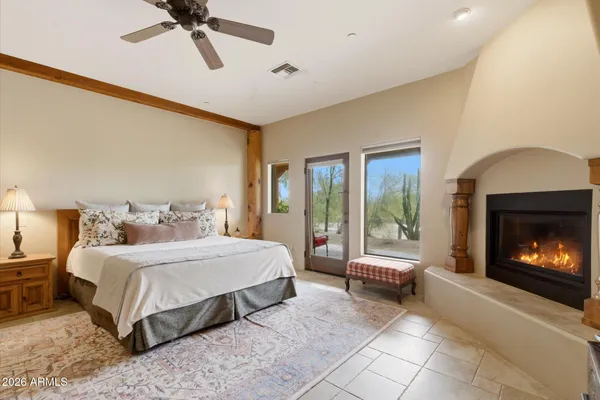 a bedroom with a bed and a fireplace