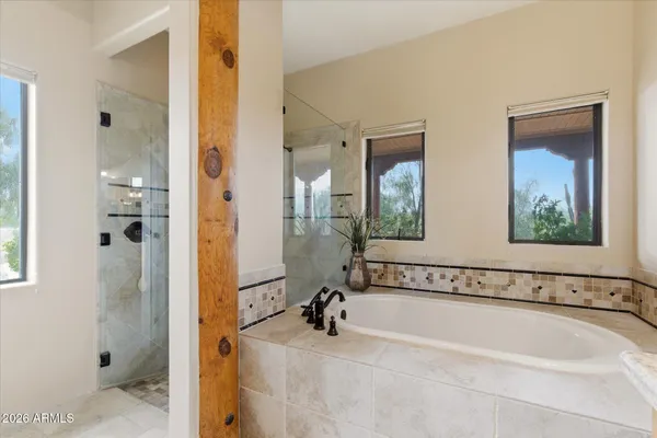 a bathroom with a bathtub and a mirror