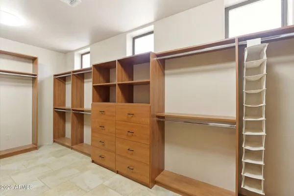 a view of walk in closet with empty racks