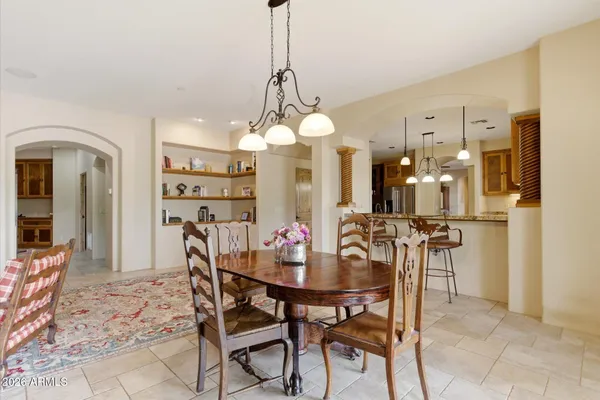 a view of a dining room with furniture and chandelier