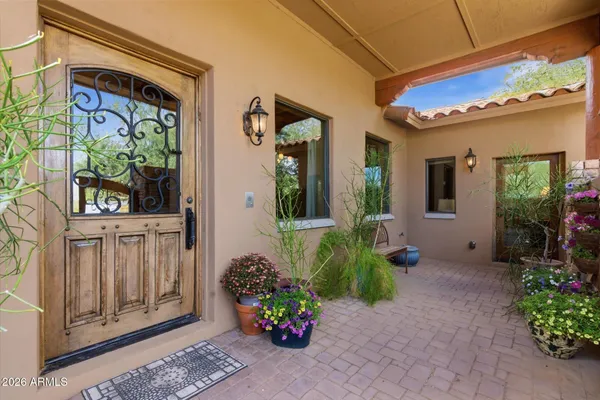 a view of a porch with potted plants