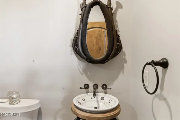 a living room with stainless steel appliances furniture a rug and kitchen view