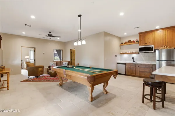a living room with furniture a ceiling fan and a window