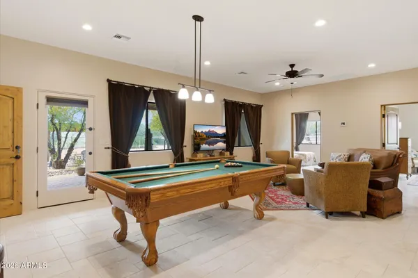 a living room with furniture a rug and a chandelier