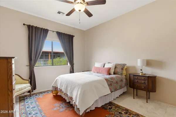 a bedroom with two beds and a window