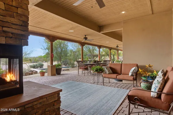 a view of a patio with a table and chairs