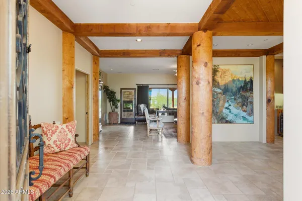a view of a livingroom with furniture and floor to ceiling window