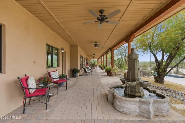 a view of backyard with large trees and wooden fence