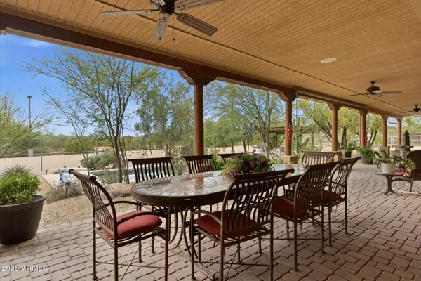 a view of patio with table and chairs and potted plants