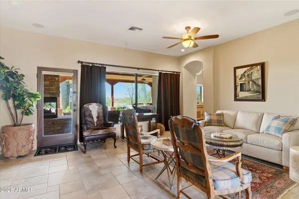 a living room with furniture a chandelier and a window