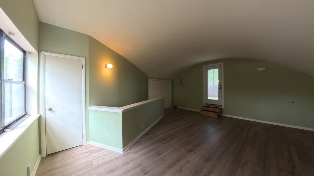 929 Red Bluff Road Pipe Creek, TX 78063 - Photo 18 of 29 a view of an empty room with wooden floor and a window