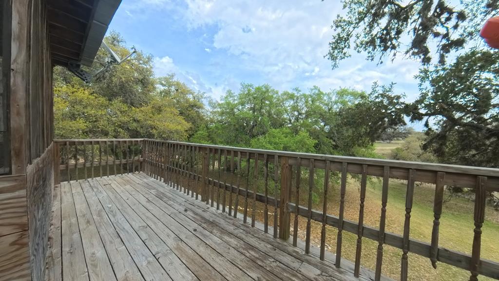 929 Red Bluff Road Pipe Creek, TX 78063 - Photo 25 of 29 a balcony with wooden floor and fence