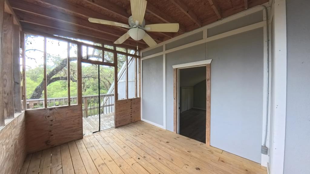 929 Red Bluff Road Pipe Creek, TX 78063 - Photo 26 of 29 a big room with wooden floor and windows