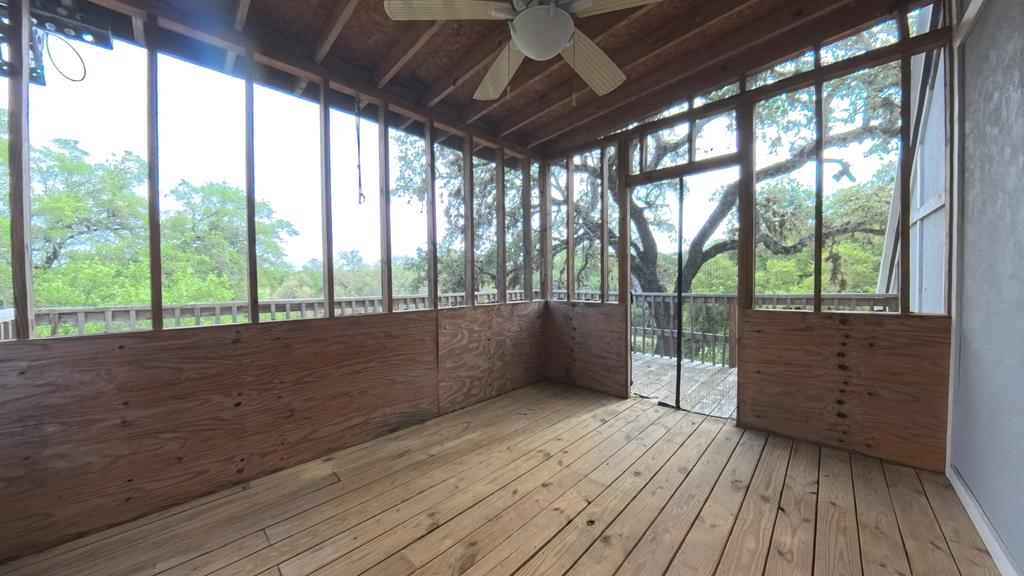 929 Red Bluff Road Pipe Creek, TX 78063 - Photo 27 of 29 a view of wooden floor and trees in a room