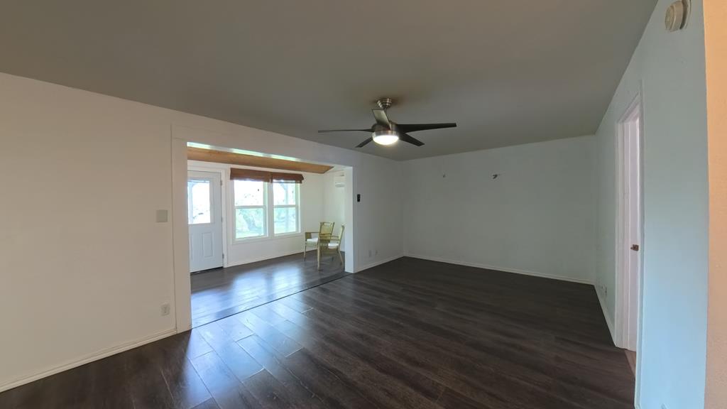 929 Red Bluff Road Pipe Creek, TX 78063 - Photo 5 of 29 a view of an empty room with wooden floor and a window