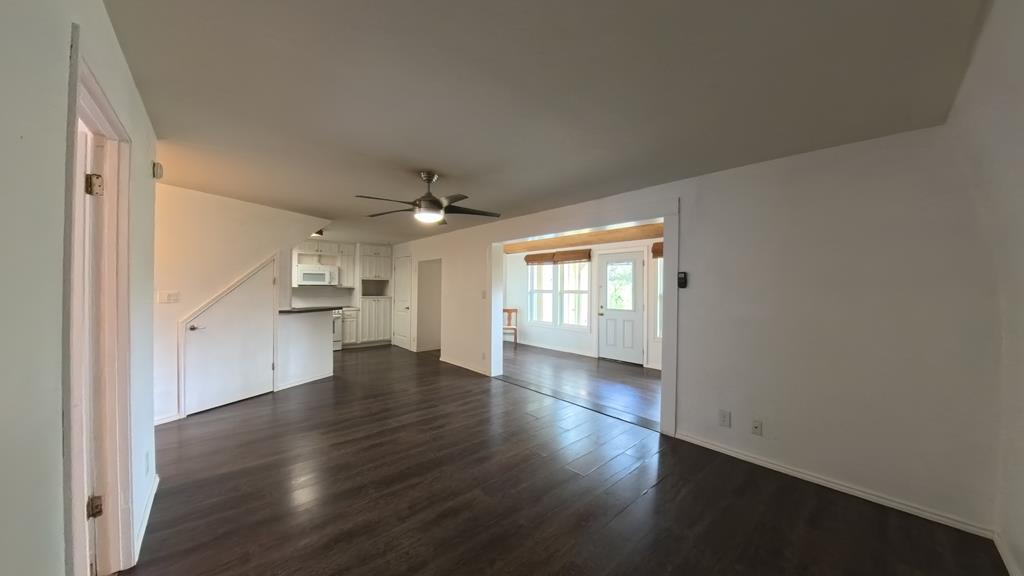 929 Red Bluff Road Pipe Creek, TX 78063 - Photo 7 of 29 an empty room with wooden floor cabinet and windows