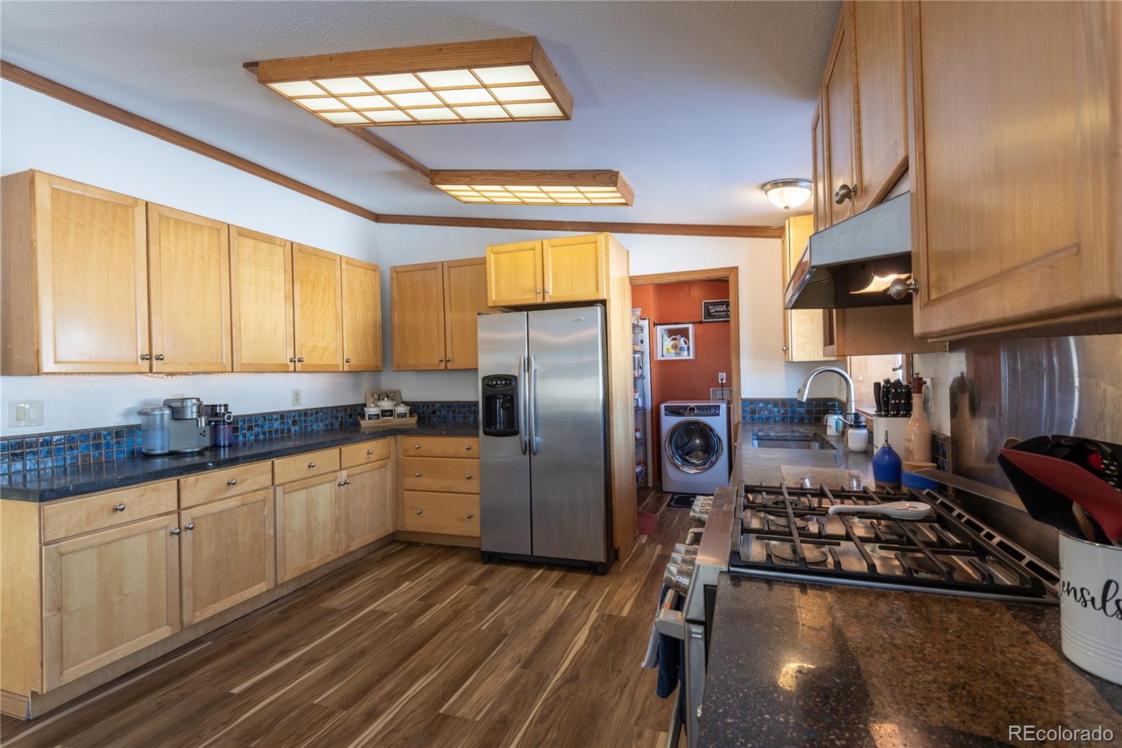 233 Ridge Road Ward, CO 80481 - Photo 13 of 36 a kitchen with stainless steel appliances granite countertop a stove refrigerator and cabinets