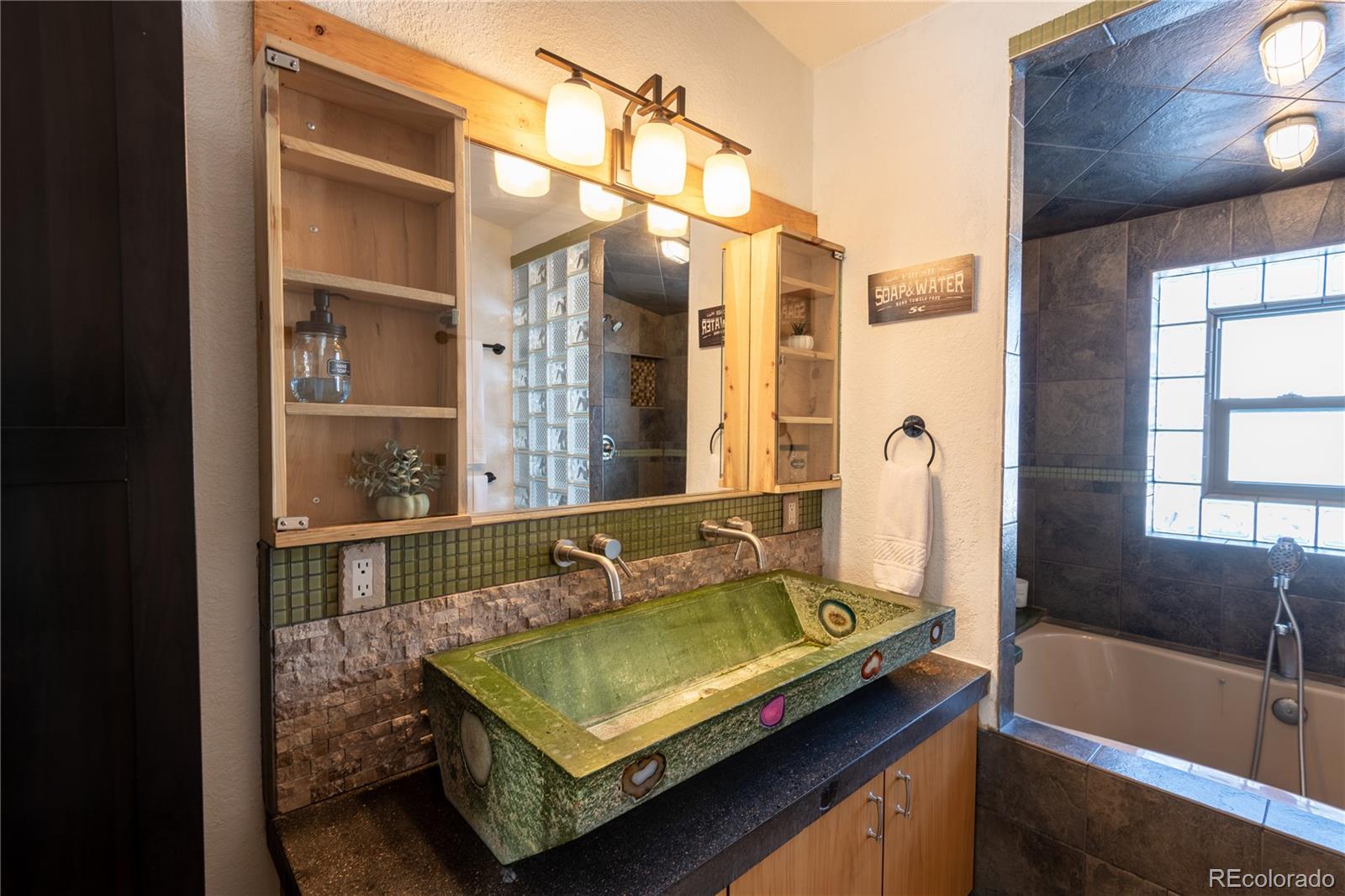 233 Ridge Road Ward, CO 80481 - Photo 19 of 36 a bathroom with a tub and a sink