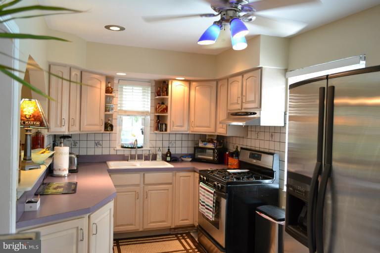 3013 Dunran Road Baltimore, MD 21222 - Photo 6 of 19 a kitchen with a sink stove and refrigerator