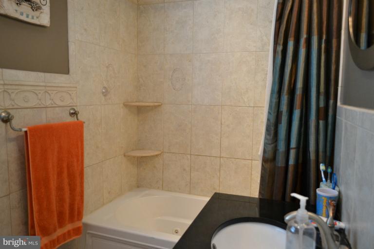 3013 Dunran Road Baltimore, MD 21222 - Photo 10 of 19 a bathroom with a sink toilet and shower