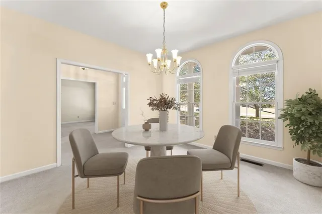 a view of a dining room with furniture and a chandelier