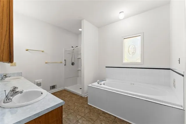 a bathroom with a bathtub and shower