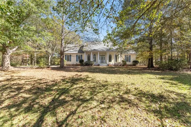 a front view of a building with a yard