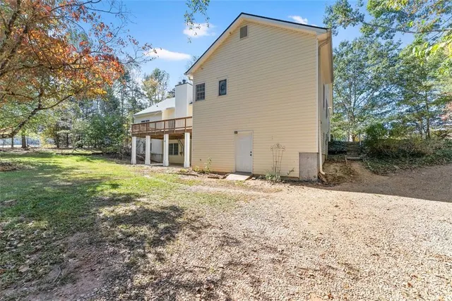 an aerial view of a house with yard and seating space