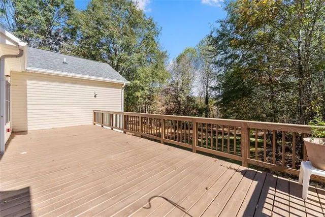 a balcony with wooden floor and fence