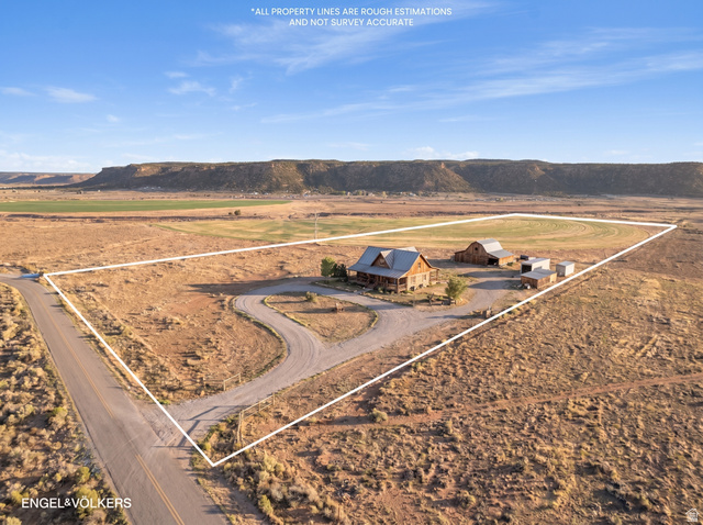 Gooseberry Way Apple Valley, UT 84737 - Photo 15 of 24 Expansive property featuring a log cabin style home with a covered front porch, a barn, and multiple outbuildings