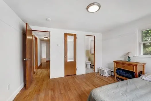 a bedroom with two beds and a window