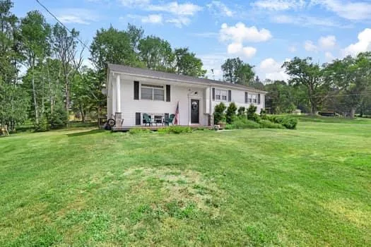 a backyard of a house with table and chairs