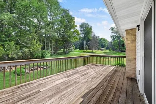 a balcony with wooden floor and fence