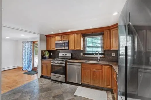 a kitchen with stainless steel appliances granite countertop a refrigerator sink and cabinets