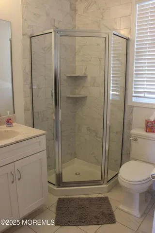 a bathroom with a shower a toilet and sink